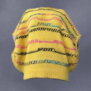 Yellow poncho style knit sweater easel